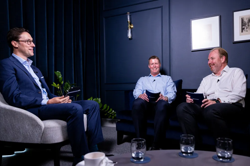 Three men speaking on a panel for a webinar